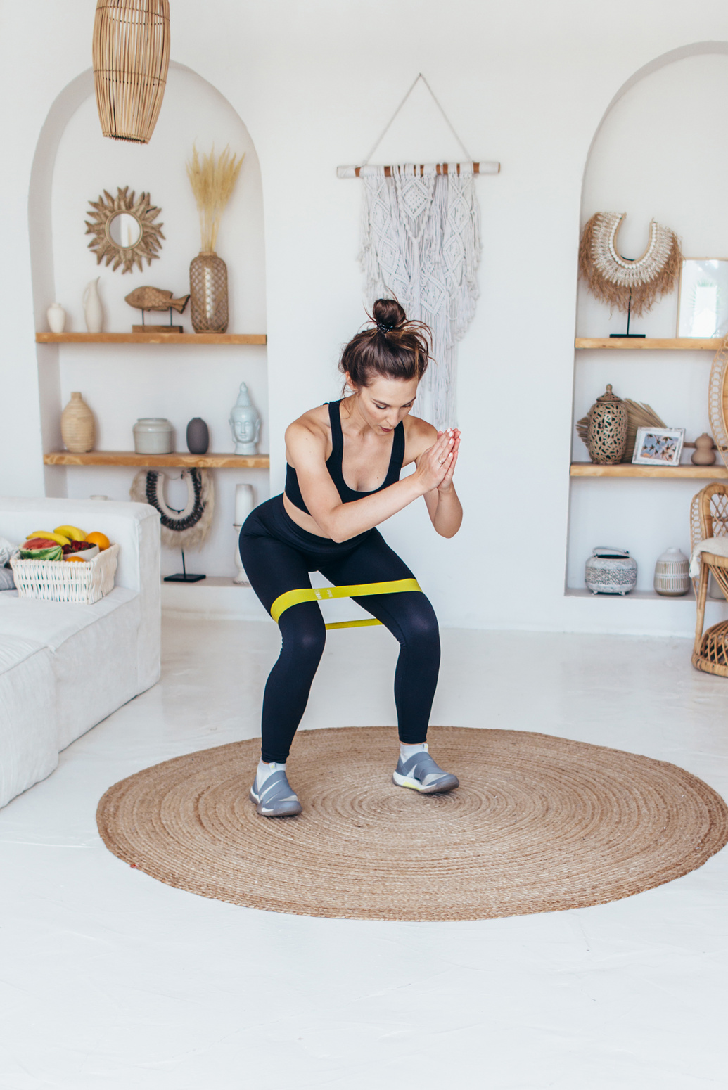 Woman Working Out at Home Doing Squats with Elastic Band.